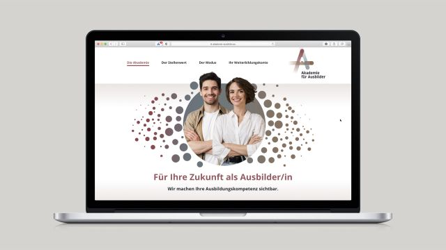 Laptop mit Homepage Akademie für Ausbilder Mann und Frau in Kreis
